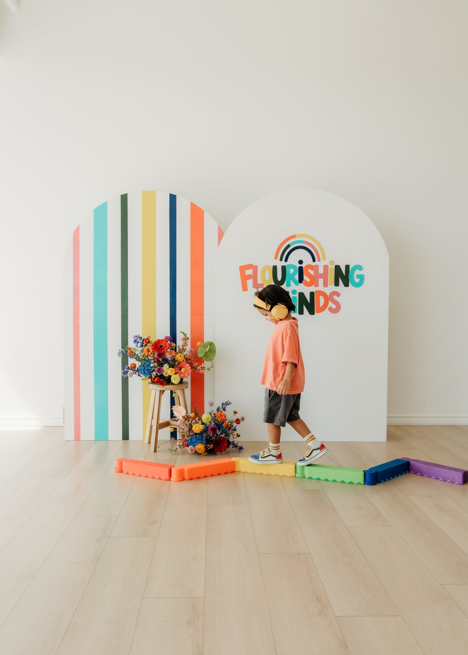 Child exploring a colorful Flourishing Minds floral studio