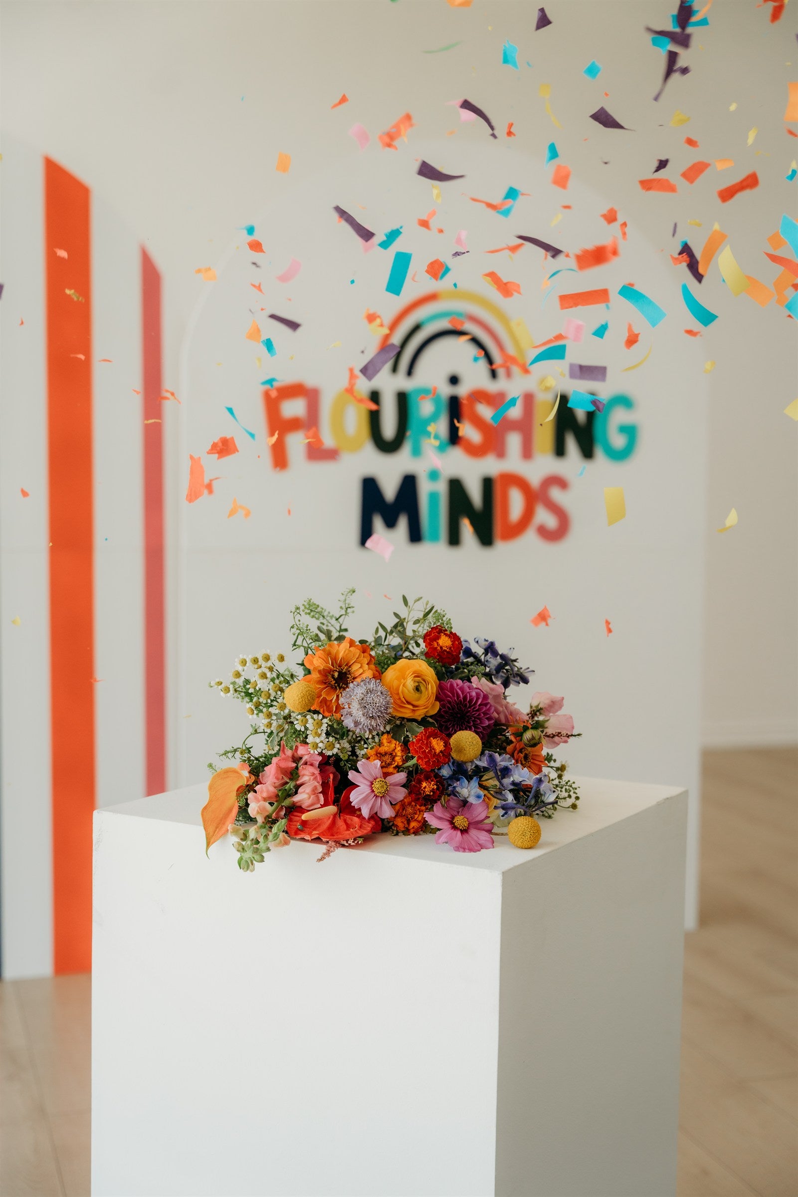 Flourishing Minds bouquet and colorful studio backdrop